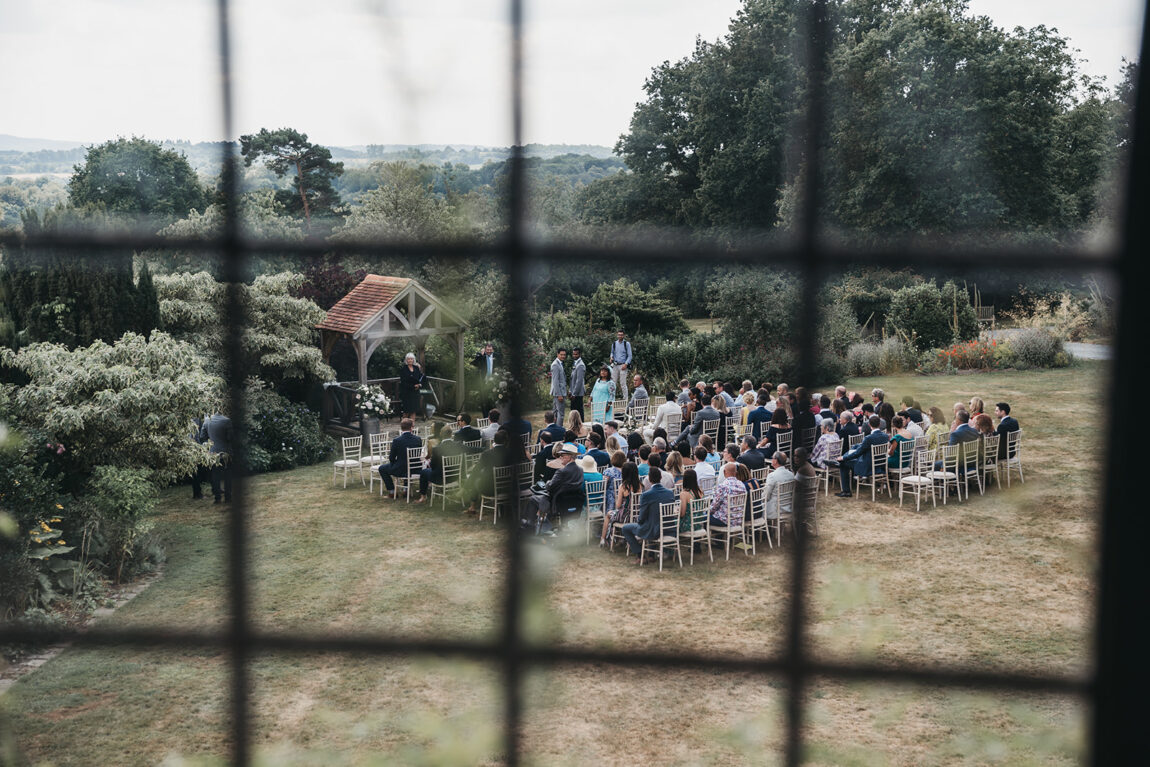 The garden ceremony at Hoath House seen through a leaded window