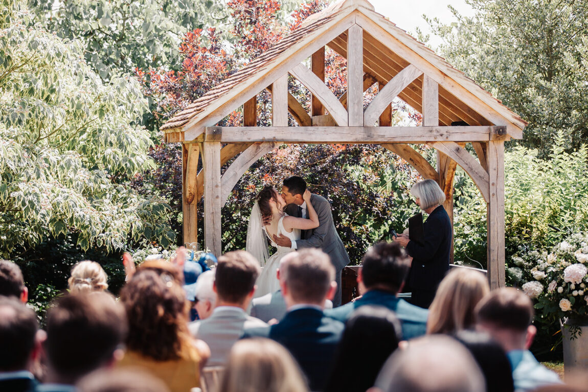 Ceremony under the oak gazebo in the garden at Hoath House