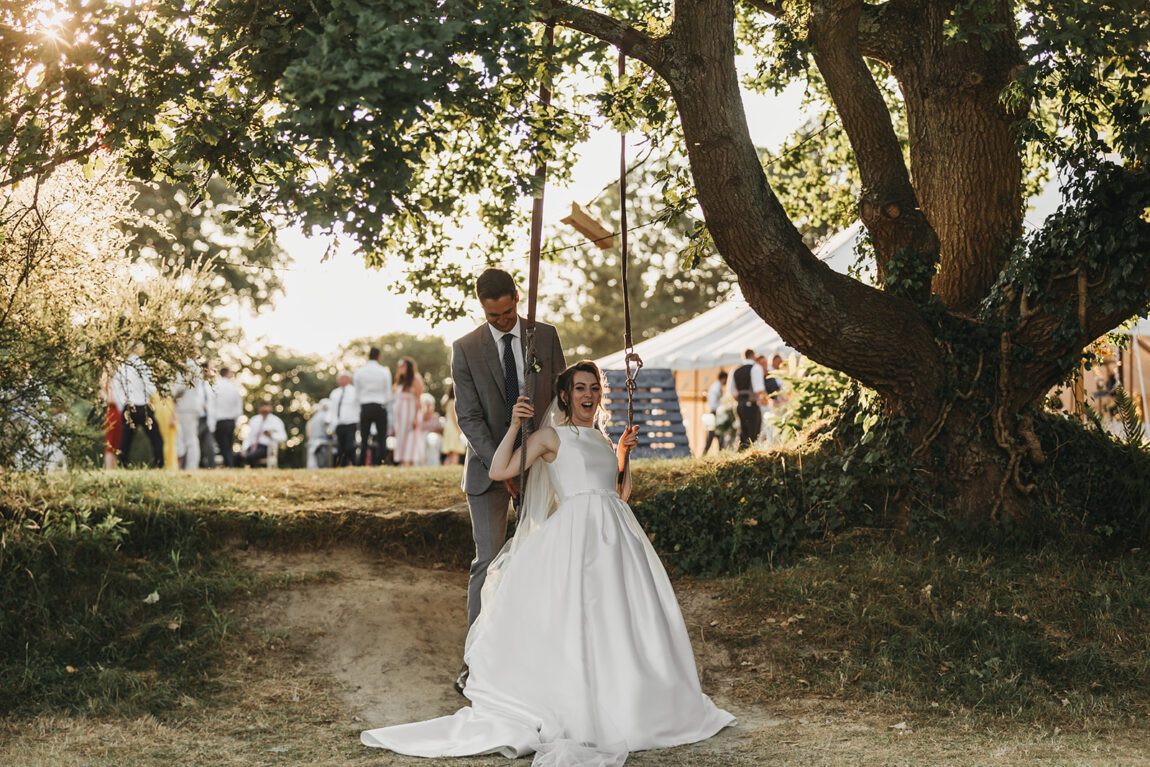 Nicola and Luke by the old oak tree at Hoath House, marquee behind
